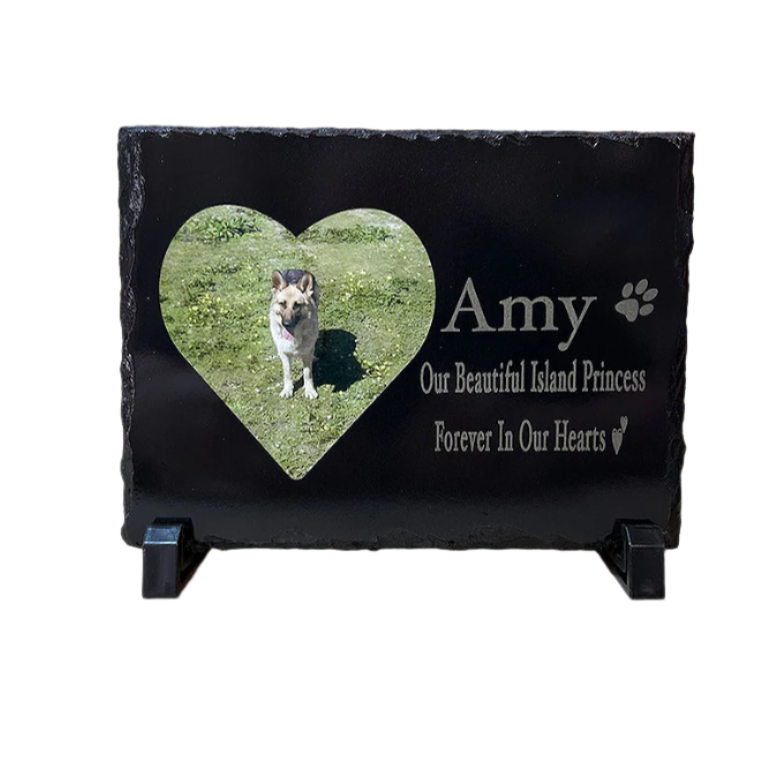 Black slate pet memorial with a heart-shaped photo of a dog and engraved text on a white background