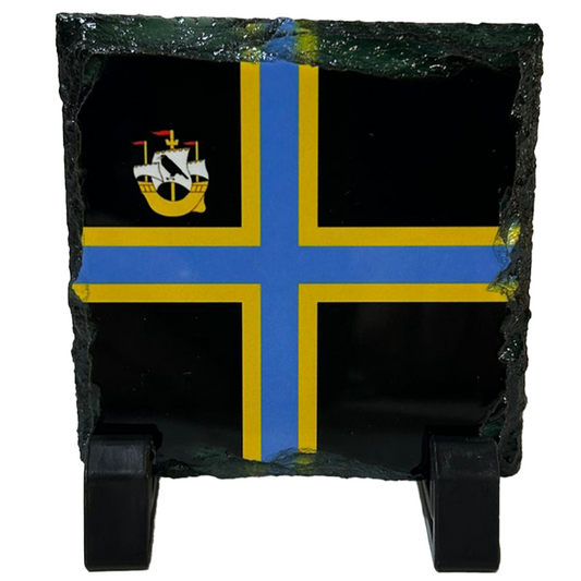 Slate coaster with a blue and yellow cross design on a black background